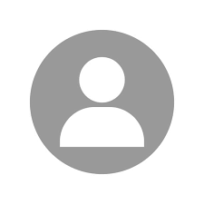 Professional female teacher avatar with brown hair, glasses, and a welcoming smile in a classroom setting